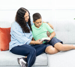 mom and child reading on a couch