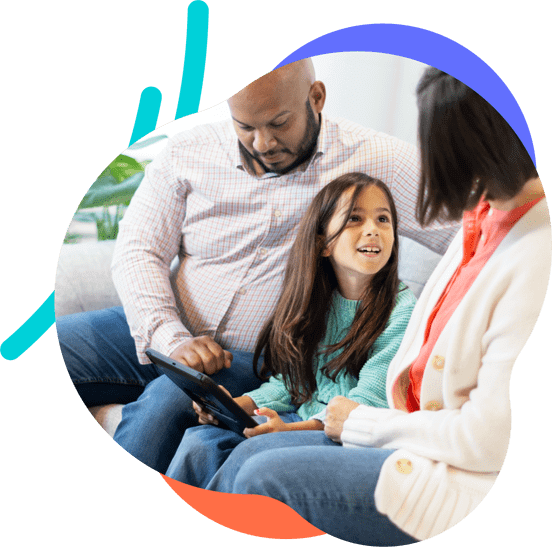 Girl sits between her parents with a tablet in her hands