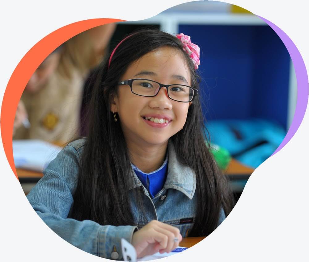 girl wearing glasses, smiling at the camera