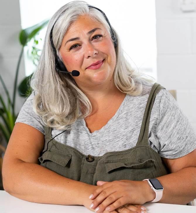 Woman smiles at camera while wearing a headset for virtual tutoring